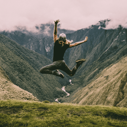 Woman leaping in mountain scene like raising influencer rates