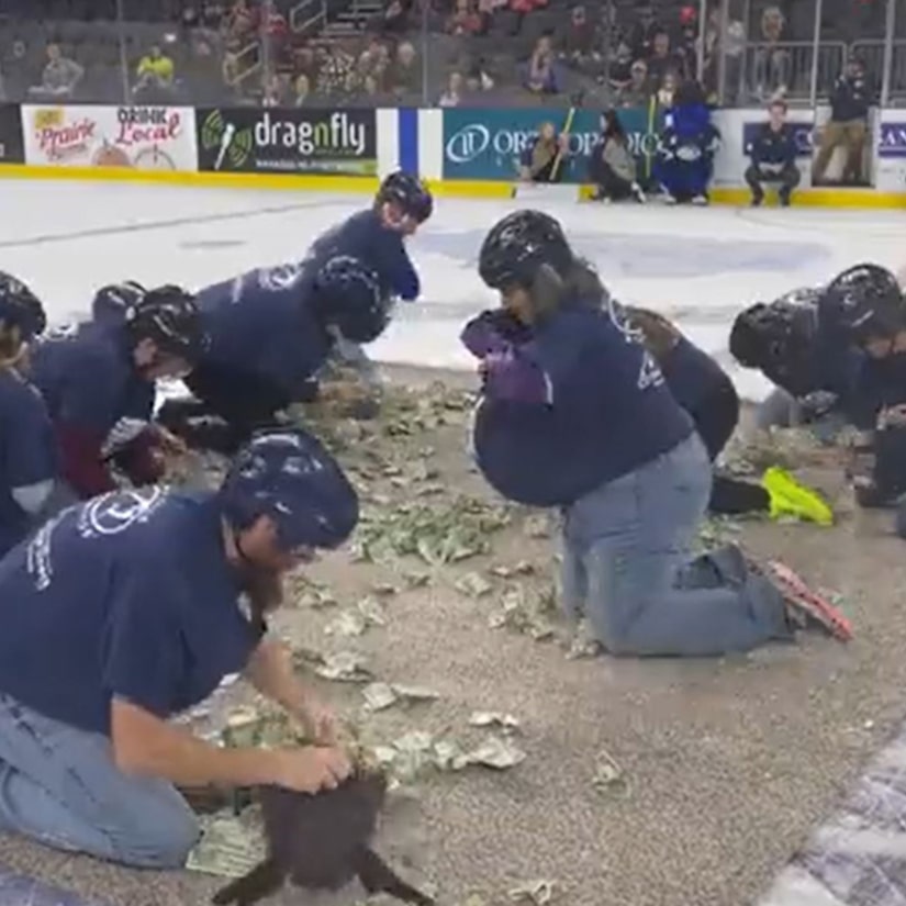 Company Slammed for Making 10 Crawling Teachers Grab for $1 Bills for School Funds During Hockey Game